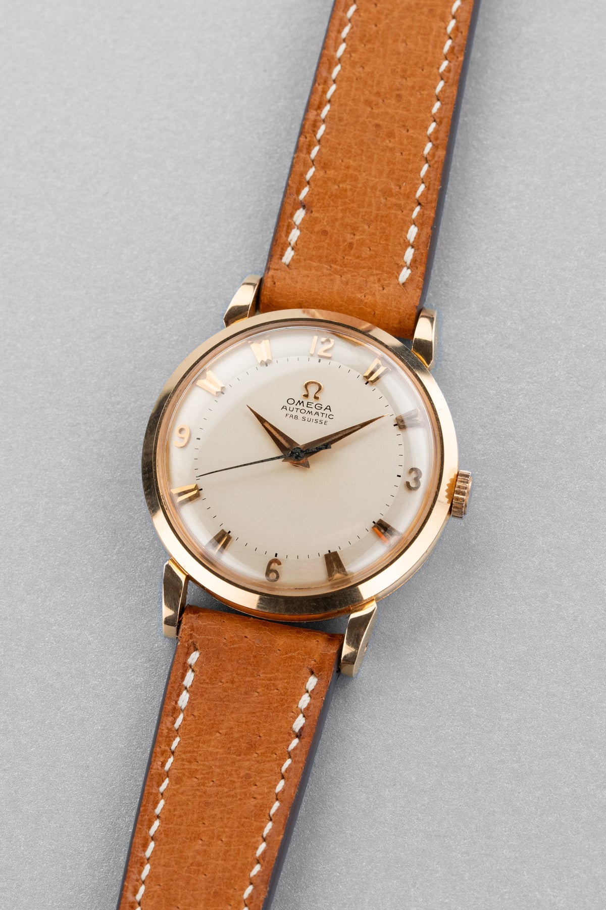AYSF Superb Omega “Fab. Suisse” Automatic in Rose Gold, circa 1953 – N.O.S. - Three Quarters