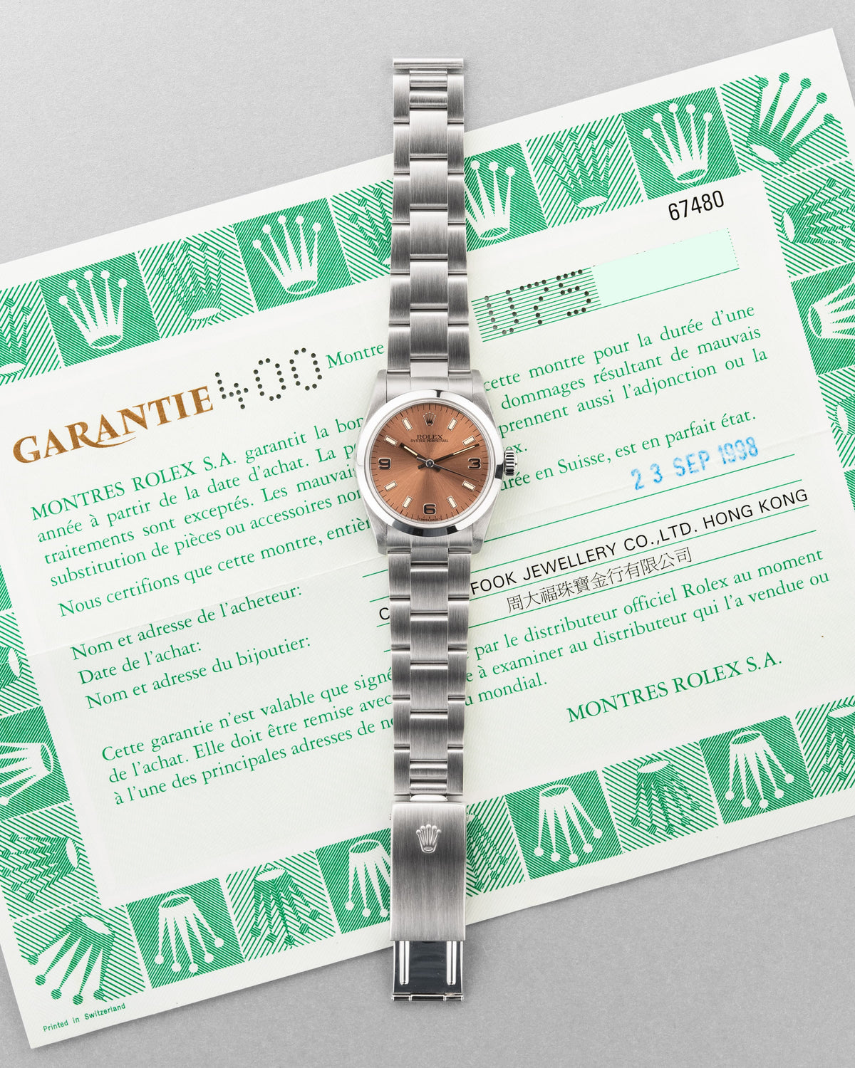 SUK2 Rolex Oyster Perpetual 31 réf. 67480 de 1997-1998 – Garantie Rolex d’origine + Cadran rose/saumon « Explorer 3-6-9 » - Papers