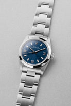 SGNE 1997 Rolex Oyster Perpetual 31 Ref. 67480 – Blue “Explorer 3-6-9” Dial, Original Warranty, Perfect Condition - Three Quarters
