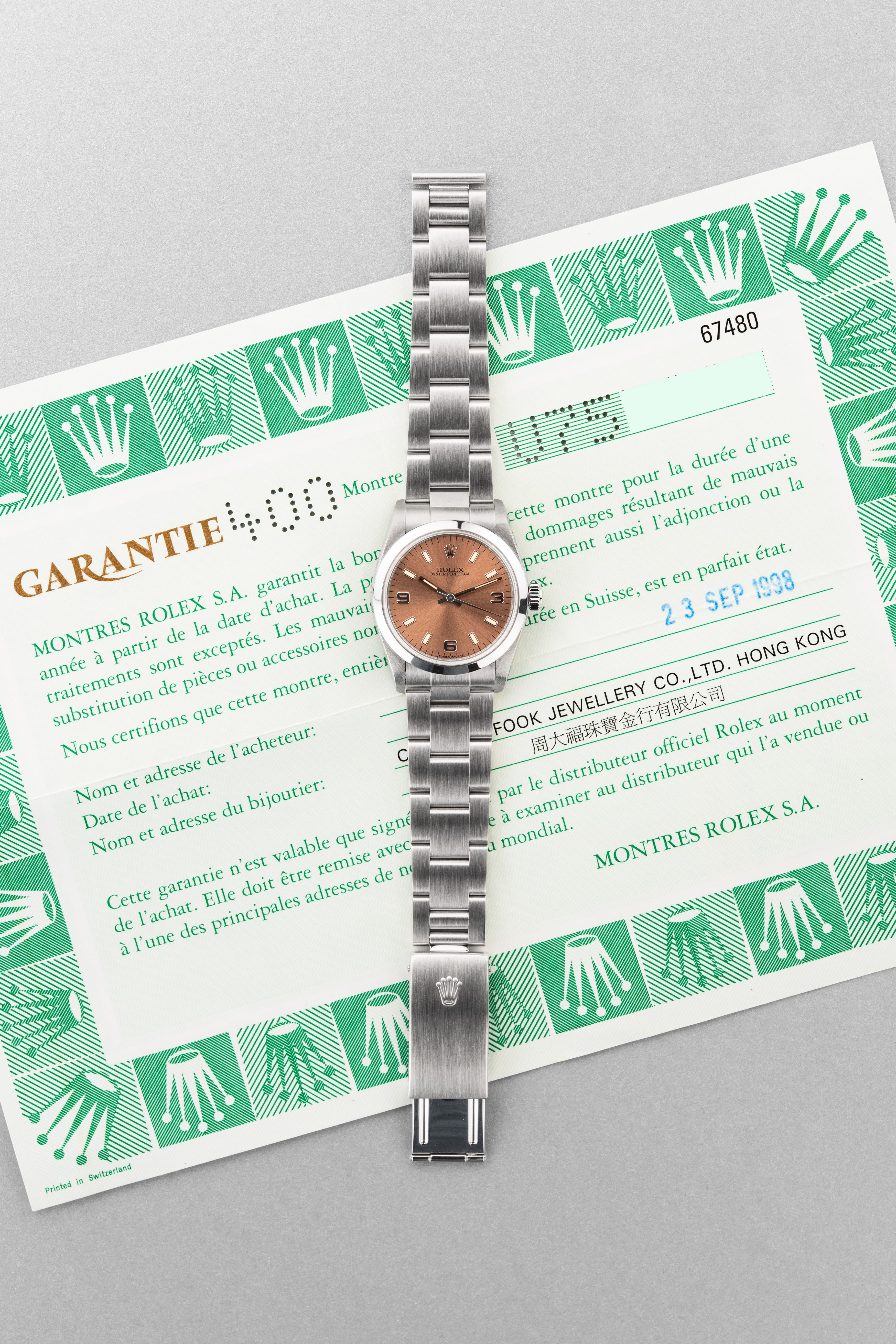 SUK2 Rolex Oyster Perpetual 31 réf. 67480 de 1997-1998 – Garantie Rolex d’origine + Cadran rose/saumon « Explorer 3-6-9 » - Papers