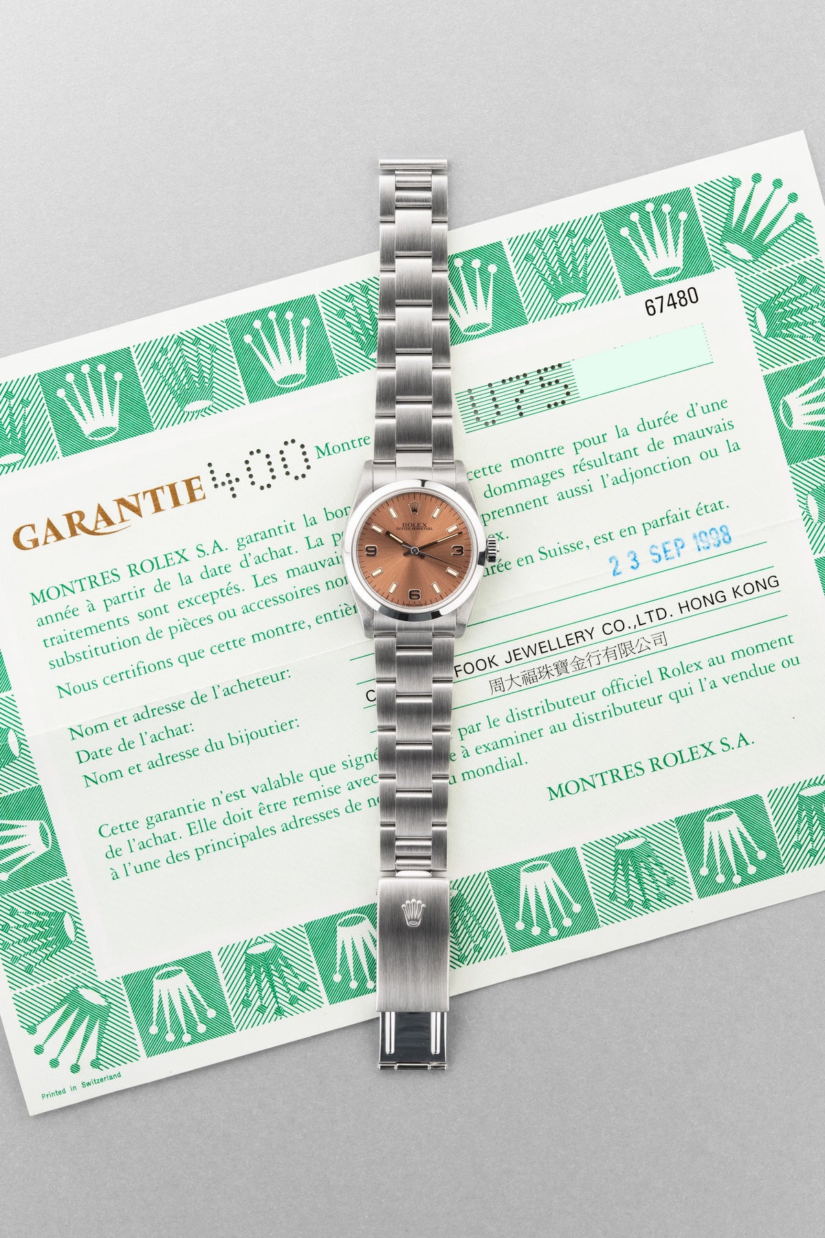 SUK2 Rolex Oyster Perpetual 31 réf. 67480 de 1997-1998 – Garantie Rolex d’origine + Cadran rose/saumon « Explorer 3-6-9 » - Papers